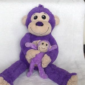 Purple monkey holding lilac baby monkey.